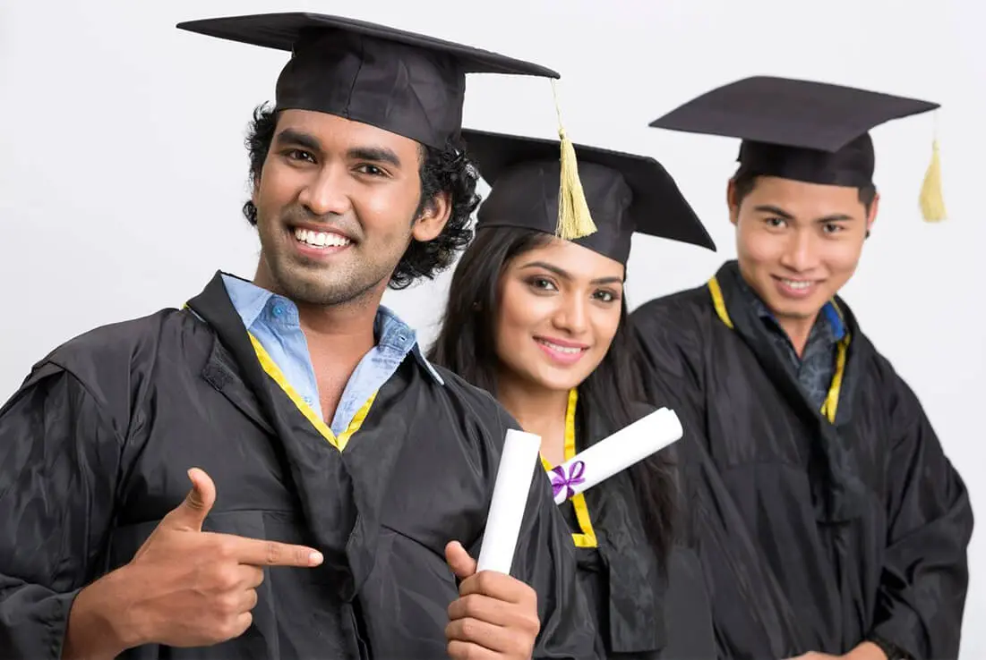 Three graduates are posing for a picture.